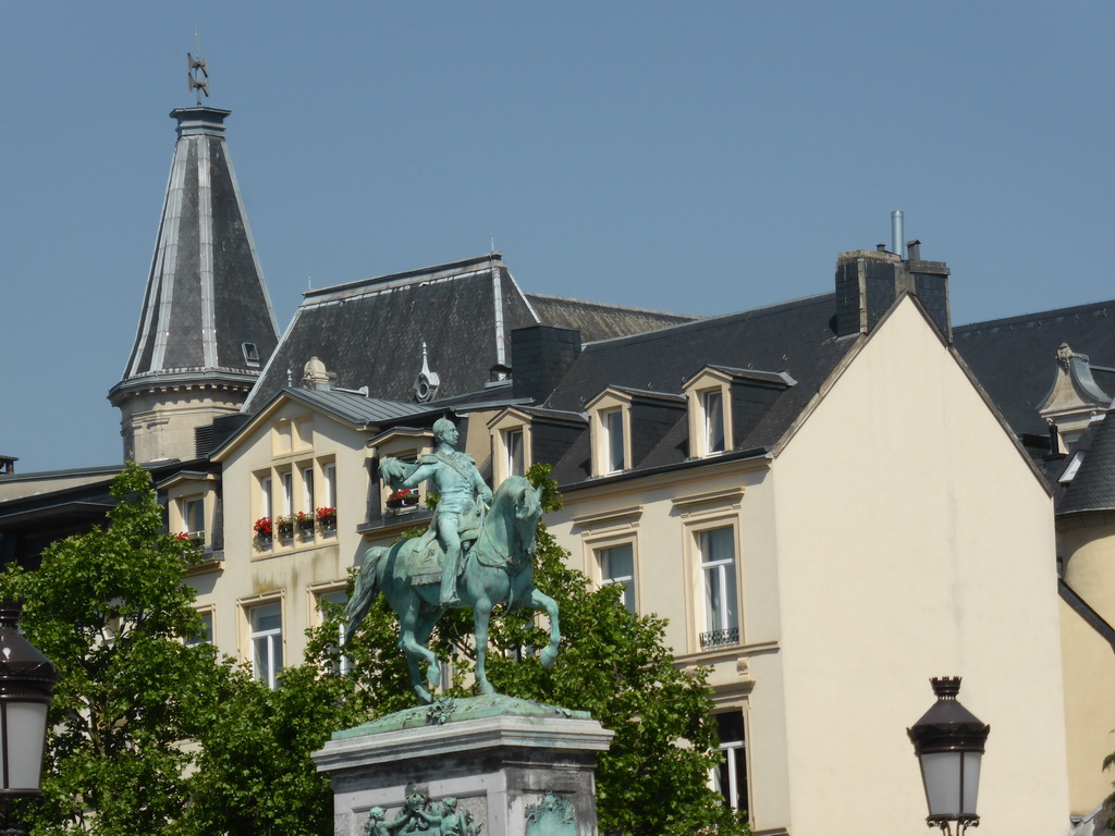 The statue of King William II of the Netherlands at the Place Guillaume II square and the tower of the Cercle Municipal building