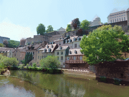 The Alzette-Uelzecht river, houses at the Grund district and the Chemin de la Corniche street, viewed from the Rue Münster bridge