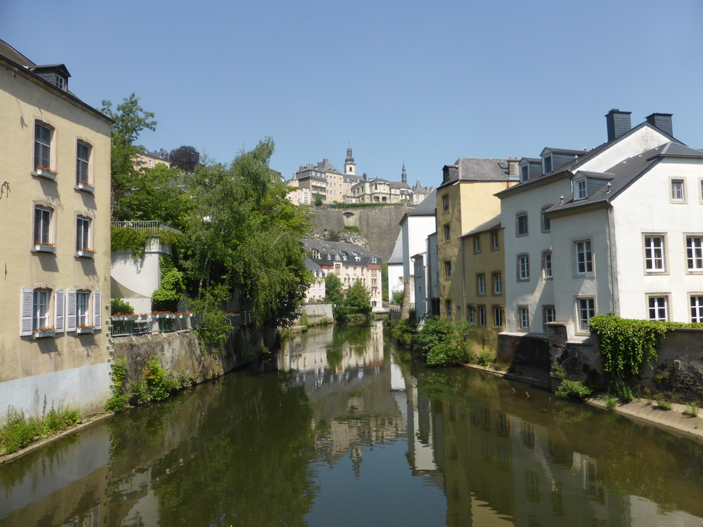 The Alzette-Uelzecht river, houses at the Grund district, the Casemates du Bock and Saint Michael`s Church, viewed from the Rue Münster bridge