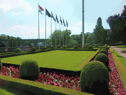 Upper garden with the flags of Luxembourg and the European Union and the Pont Adolphe bridge over the Vallée de la Pétrusse valley