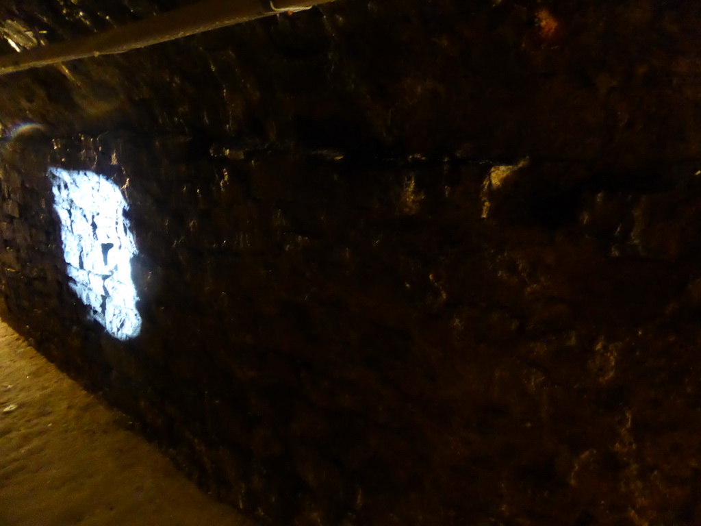 Light shining through a loophole on the wall of a tunnel at the Bastion side of the Casemates de la Pétrusse