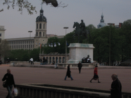 The Place Bellecour square with an equestrian statue of King Louis XIV, and the Clock Tower of the Hôpital de la Charité de Lyon building at the Place Antonin Poncet square