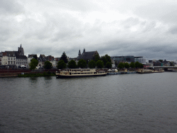 Boats in the Maas river and the city center with the Augustijnenkerk church and the Mosae Forum shopping center, viewed from the Sint Servaasbrug bridge