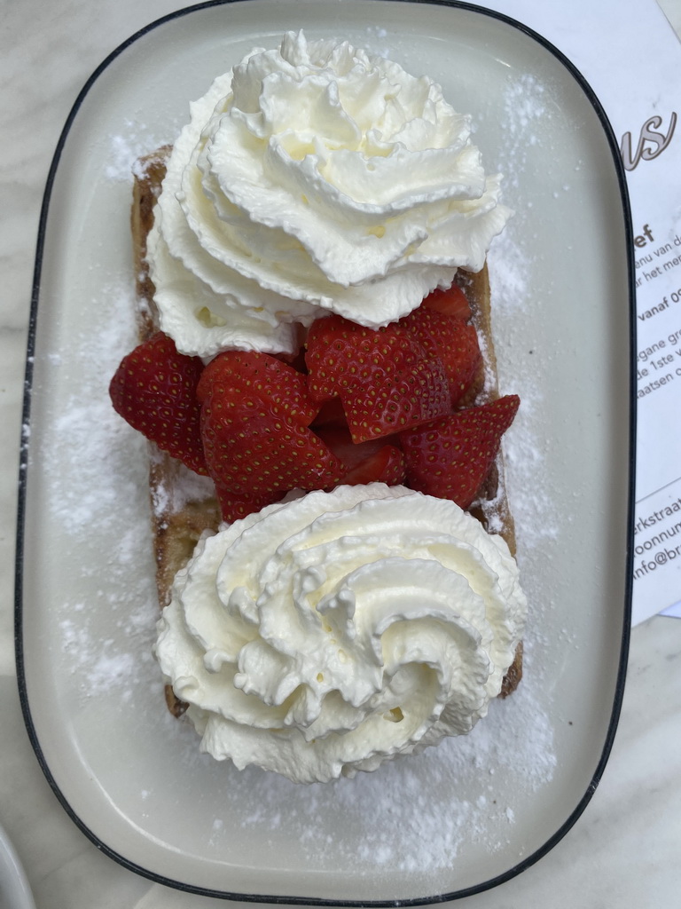 Waffle with strawberries and whipped cream at the terrace of the Brasserie Amadeus restaurant at the Dominicanerplein square