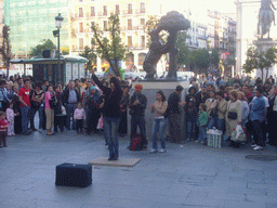 Street artists at the statue of a bear and a madrone tree, at the Puerta del Sol square