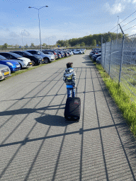 Max with his suitcase at the parking lot of Eindhoven Airport