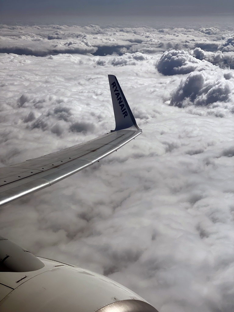 Clouds and the wing of the airplane from Eindhoven