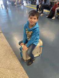 Max on his suitcase at the Arrivals Hall at the Francisco Sá Carneiro Airport