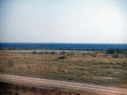 Peberholm island and windmills at the south side of the Öresund Bridge, viewed from the train from Malmö to Copenhagen