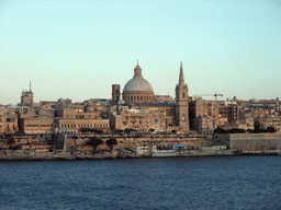 Marsamxett Harbour and Valletta with the dome of the Carmelite Church and the tower of St Paul`s Pro-Cathedral, at sunset