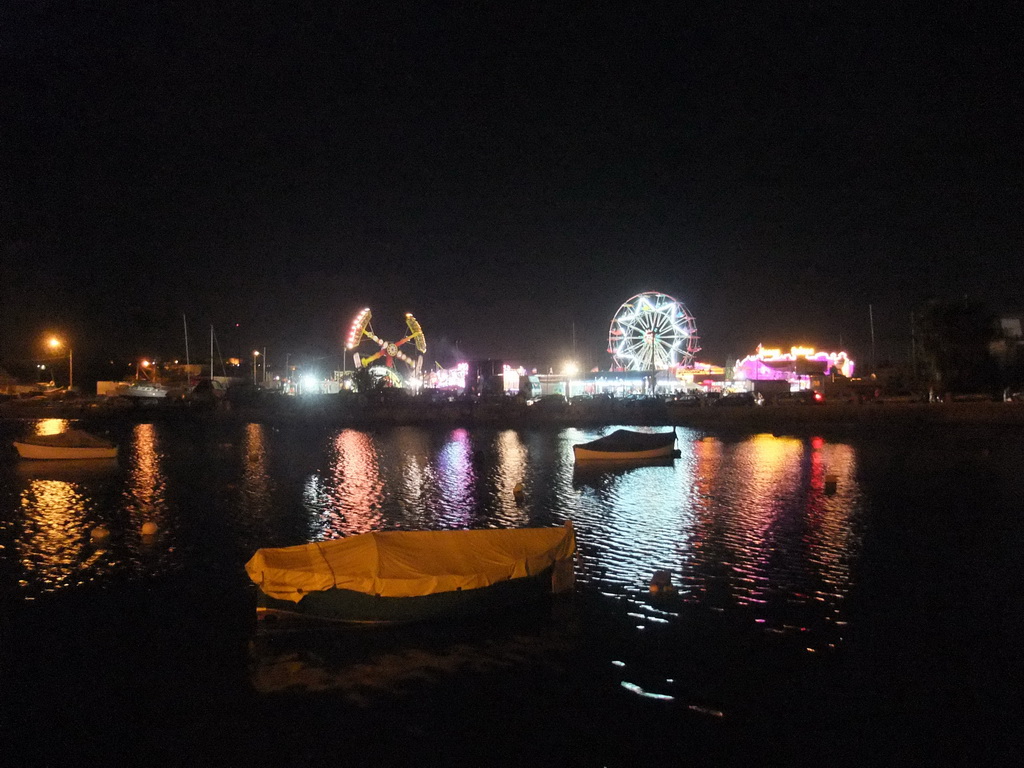 Boats in Marsamxett Harbour and Manoel Island with funfair attractions, by night