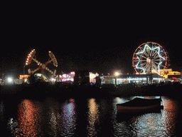 Boat in Marsamxett Harbour and Manoel Island with funfair attractions, by night