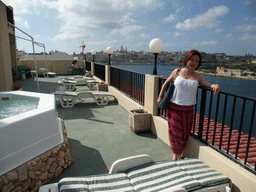 Miaomiao with the jacuzzi at the roof terrace of the Marina Hotel, with a view on Marsamxett Harbour, Manoel Island and Valletta with the dome of the Carmelite Church and the tower of St Paul`s Pro-Cathedral