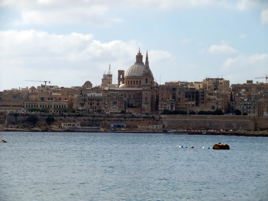 Marsamxett Harbour and Valletta with the dome of the Carmelite Church and the tower of St Paul`s Pro-Cathedral, viewed from the Luzzu Cruises tour boat from Sliema to Marsaxlokk