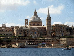 Marsamxett Harbour and Valletta with the dome of the Carmelite Church and the tower of St Paul`s Pro-Cathedral, viewed from the Luzzu Cruises tour boat from Sliema to Marsaxlokk