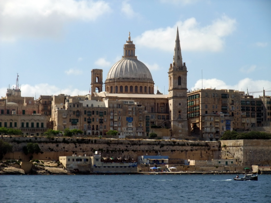 Marsamxett Harbour and Valletta with the dome of the Carmelite Church and the tower of St Paul`s Pro-Cathedral, viewed from the Luzzu Cruises tour boat from Sliema to Marsaxlokk