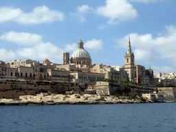 Marsamxett Harbour and Valletta with the dome of the Carmelite Church and the tower of St Paul`s Pro-Cathedral, viewed from the Luzzu Cruises tour boat from Sliema to Marsaxlokk