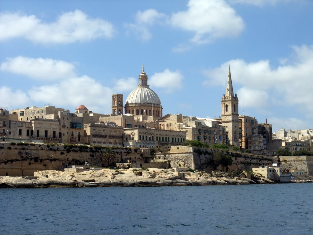 Marsamxett Harbour and Valletta with the dome of the Carmelite Church and the tower of St Paul`s Pro-Cathedral, viewed from the Luzzu Cruises tour boat from Sliema to Marsaxlokk