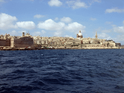 Valletta with Fort Saint Elmo, the dome of the Carmelite Church and the tower of St Paul`s Pro-Cathedral, viewed from the Luzzu Cruises tour boat from Sliema to Marsaxlokk