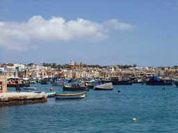 Fishing boats in the harbour of Marsaxlokk and the Church of Our Lady of Pompeii, viewed from the Luzzu Cruises tour boat from Sliema to Marsaxlokk