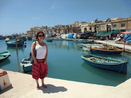 Miaomiao with the fish market and fishing boats at the harbour of Marsaxlokk