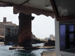 The Luzzu Cruises tour boat from Marsaxlokk to Sliema, passing through the pier at Fort Saint Elmo at Valletta
