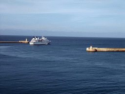 Boat in the Grand Harbour with the pier at Fort Saint Elmo and the pier at Fort Ricasoli, viewed from the Siege Bell Monument at Valletta