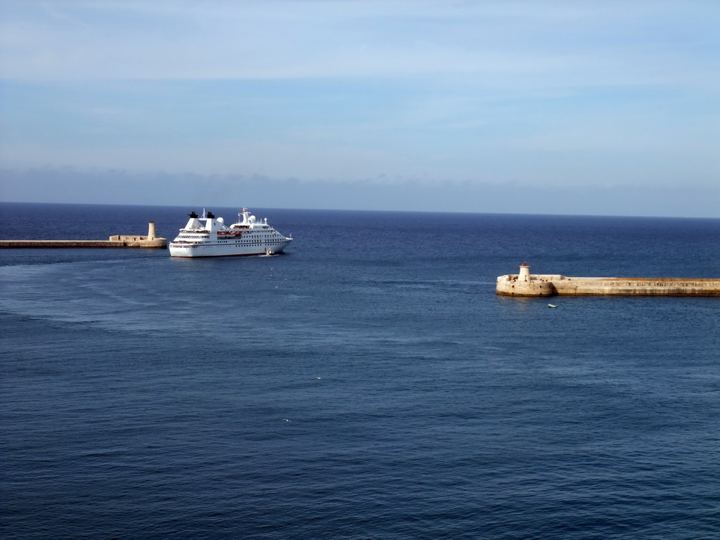 Boat in the Grand Harbour with the pier at Fort Saint Elmo and the pier at Fort Ricasoli, viewed from the Siege Bell Monument at Valletta