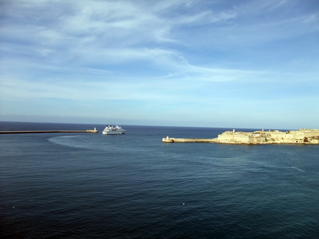 Boat in the Grand Harbour with the pier at Fort Saint Elmo and the pier at Fort Ricasoli, viewed from the Siege Bell Monument at Valletta