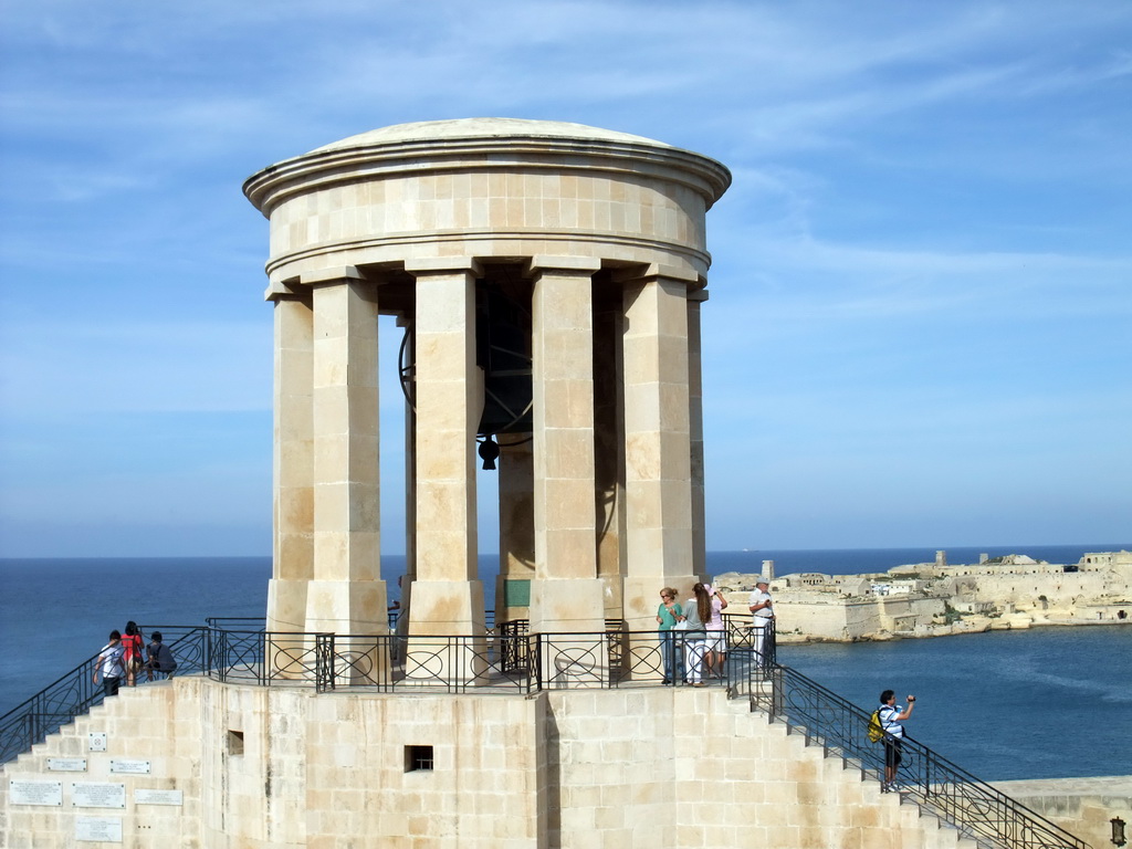 The Siege Bell Monument, the Grand Harbour and Fort Ricasoli, viewed from the Lower Barracca Gardens at Valletta