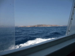 St Paul`s Island (Selmunett) with the statue of St. Paul, viewed from the Luzzu Cruises tour boat from Malta to Gozo