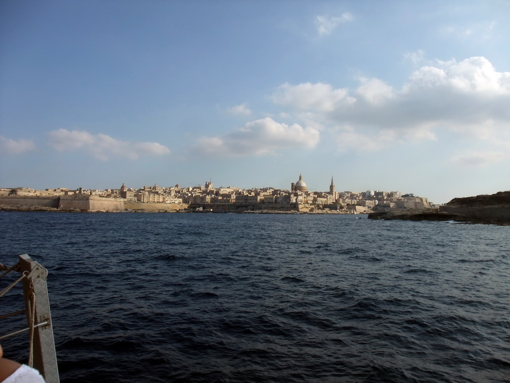 Valletta with Fort Saint Elmo, the dome of the Carmelite Church and the tower of St Paul`s Pro-Cathedral, viewed from the Luzzu Cruises tour boat from Comino to Malta