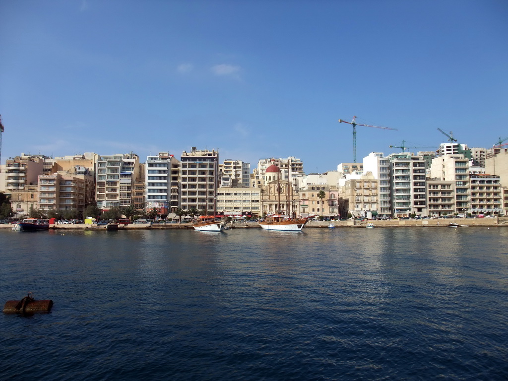 The Tigné Seafront with the front of the Marina Hotel and the Parish Church of Jesus of Nazareth, viewed from the Luzzu Cruises tour boat from Comino to Malta