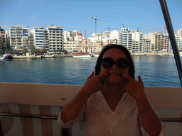 Miaomiao on the Luzzu Cruises tour boat from Comino to Malta, with a view on the Tigné Seafront with the front of the Marina Hotel and the Parish Church of Jesus of Nazareth