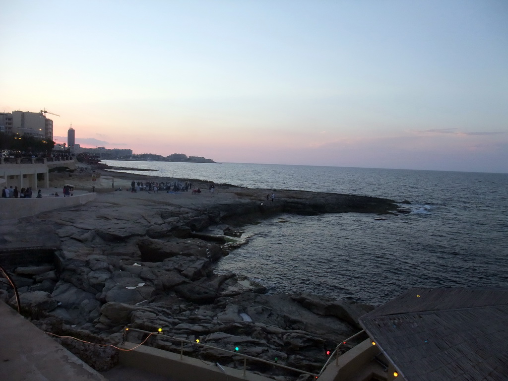 The beach of Sliema with a film crew, viewed from the terrace of the restaurant `Il-Fortizza` at the Triq It-Torri street at Sliema, at sunset