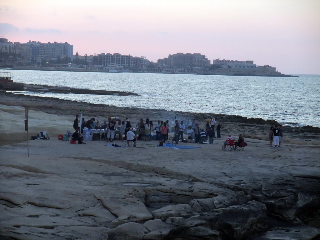 The beach of Sliema with a film crew, viewed from the terrace of the restaurant `Il-Fortizza` at the Triq It-Torri street at Sliema, at sunset
