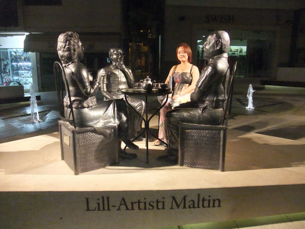 Miaomiao with metal statues at Bisazza street at Sliema, by night