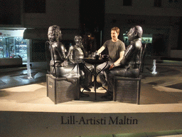 Tim with metal statues at Bisazza street at Sliema, by night