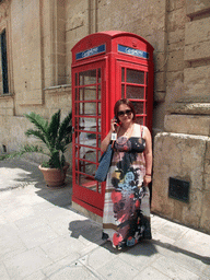 Miaomiao at a telephone booth at St. Paul`s Square at Mdina