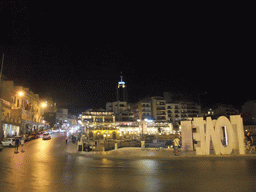 Spinola Bay at St. Julian`s, with restaurants and the Hilton Malta Hotel, by night