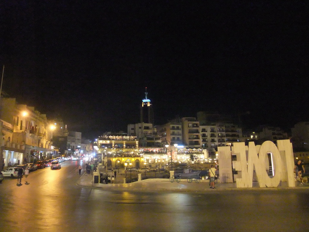 Spinola Bay at St. Julian`s, with restaurants and the Hilton Malta Hotel, by night