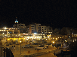 Spinola Bay at St. Julian`s, with restaurants and the Hilton Malta Hotel, by night