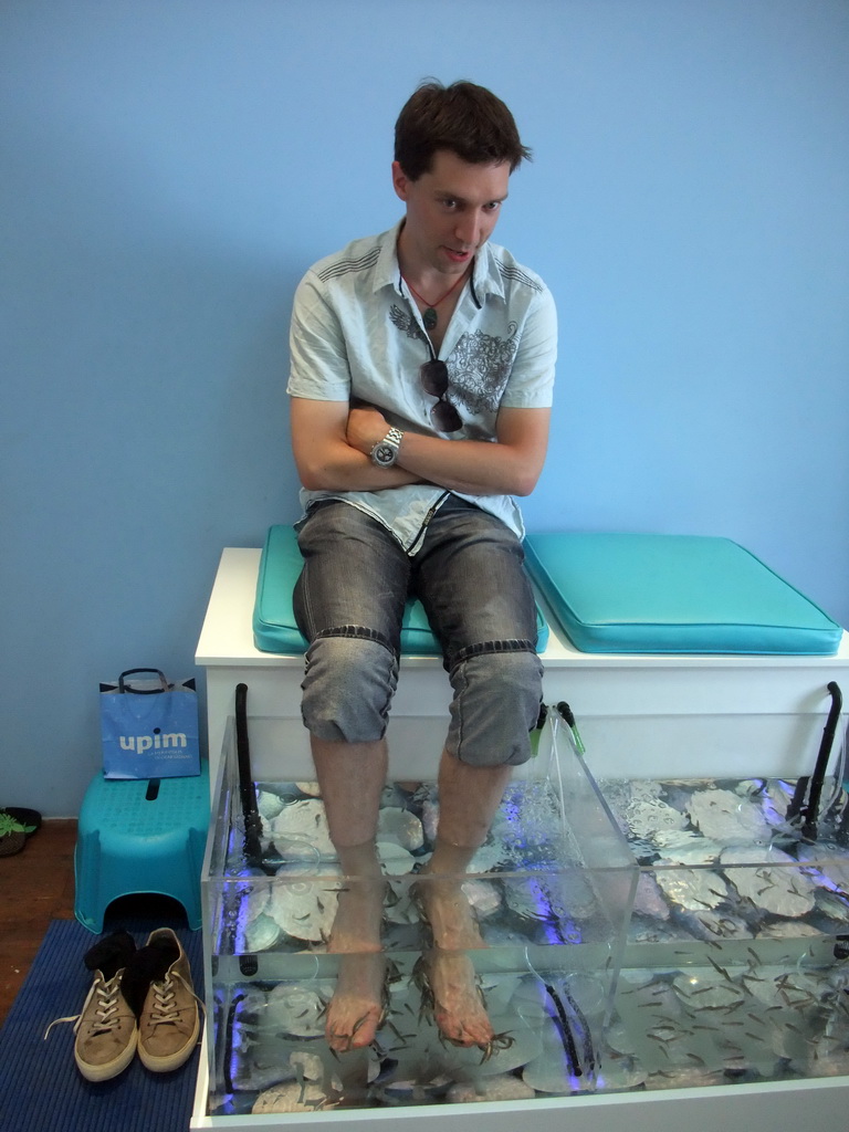 Tim with little fish in the `Bubbles - Dr Fish Foot Spa` at Sliema