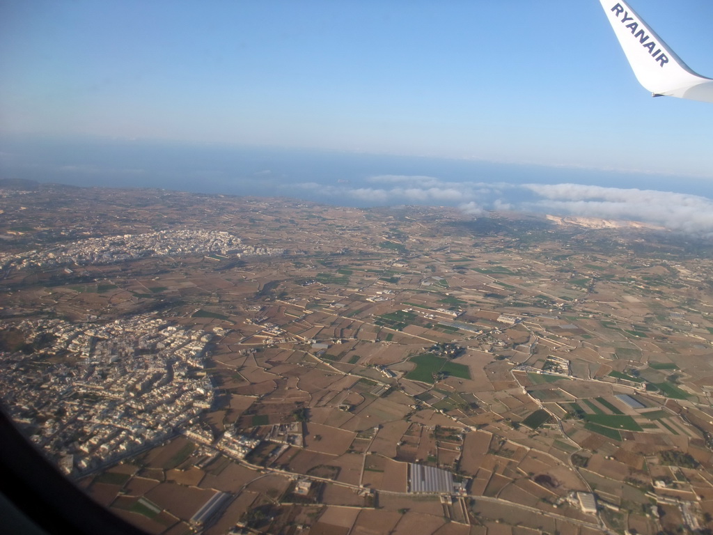 The towns of Zebbug and Siggiewi and the south coastline of Malta, viewed from the airplane from Malta to Eindhoven