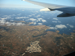 The town of Mgarr and Golden Bay, Ghajn Tuffieha Bay and Gnejna Bay at the west coastline of Malta, viewed from the airplane from Malta to Eindhoven