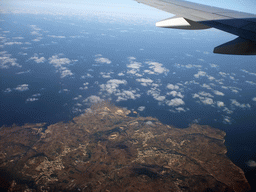 The towns of San Lawrenz, Gharb, Kercem and Xlendi and Dwejra Bay with the Fungus Rock at the west coastline of Gozo, viewed from the airplane from Malta to Eindhoven