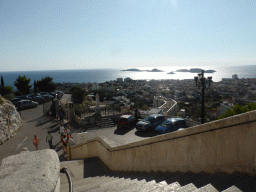 The staircase to the Notre-Dame de la Garde basilica and a view on the Pomègues and Ratonneau islands and the Château d`If castle