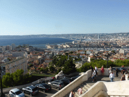 The staircase to the Notre-Dame de la Garde basilica and a view on the Old Port, the harbour of Marseille, the CMA CGM Tower and the Marseille Cathedral