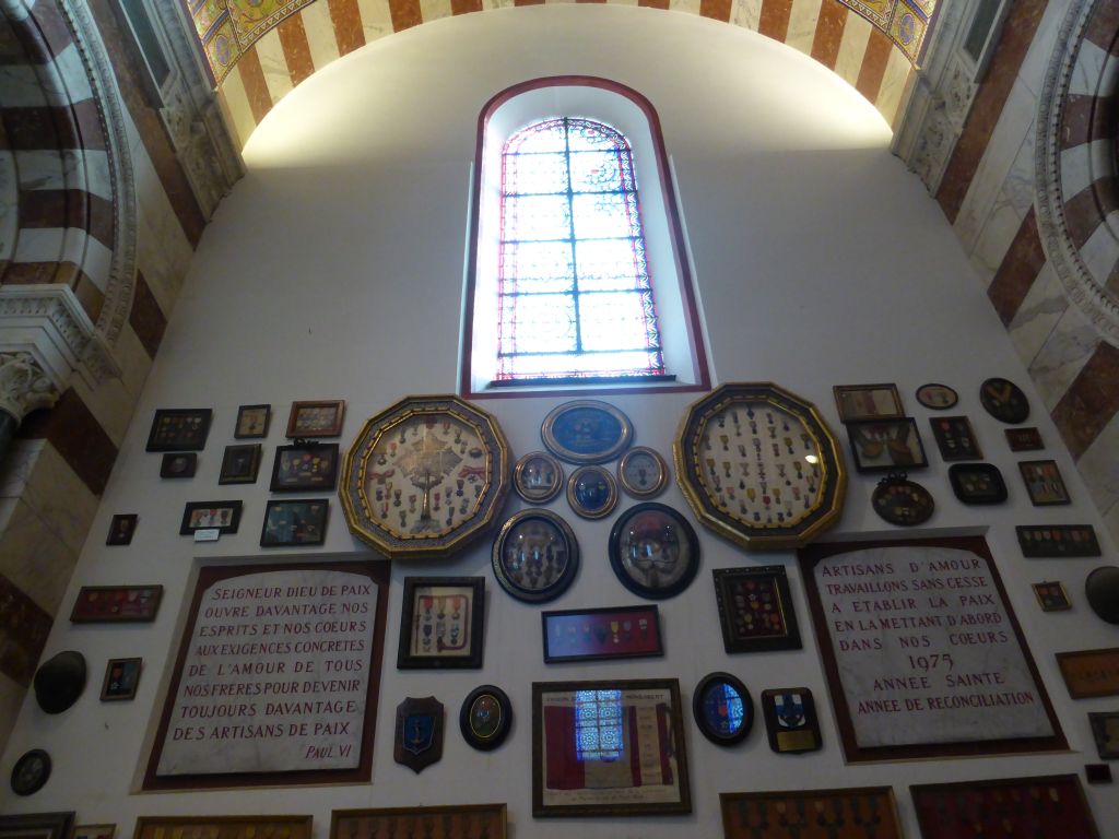 Medals and stained glass window at the first right side chapel of the Notre-Dame de la Garde basilica