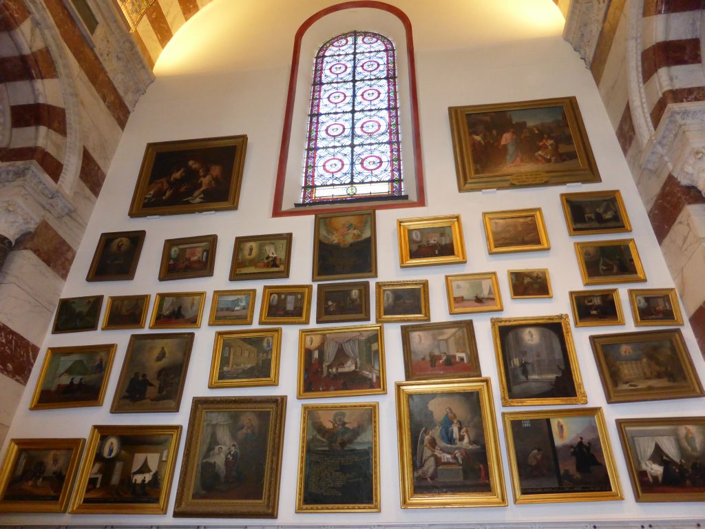 Paintings and stained glass window at the second left side chapel of the Notre-Dame de la Garde basilica